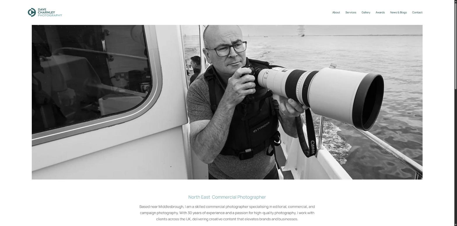 webdev-07 Screenshot of the Dave Charnley Photography website About page, showing a black and white photo of Dave with a long lens on a boat